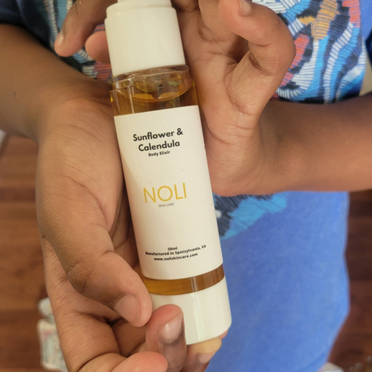 Child holding Sunflower & Calendula Body Elixir.